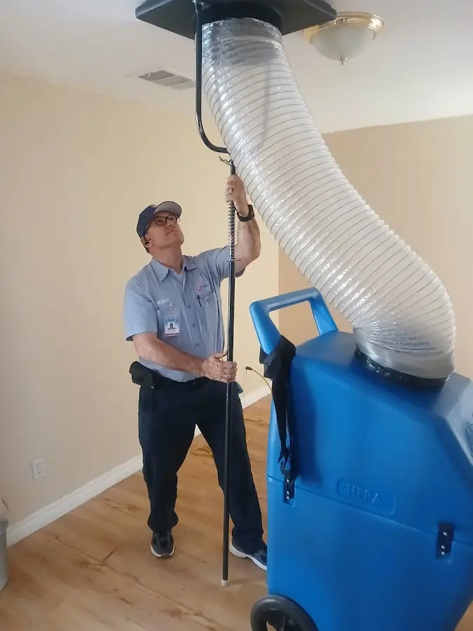Furnace Tune-Up technician using HEPA equipment in Sanger